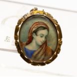 A 19th Century yellow metal brooch with painted portrait of a Lady with red shawl,