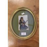 A late Victorian painting of a female mandolin player on opaque glass, signed D. L.