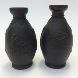 A pair of small Basalt black Wedgwood bulbous vases with neo classical decoration