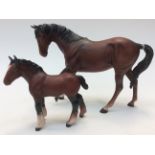 A Beswick Bay Brown horse and a Bay Brown foal,