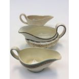 A Wedgwood cream ware creamer, with two further Wedgwood creamers,