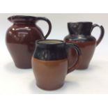Bourne Denby, Three Denby GPO jugs with brown and black, one stamped GPO to base, glazing,