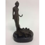 A Bronze figure of a Lady on a Marbel base 24cm in height.