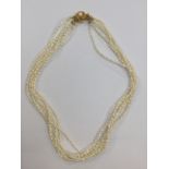 A six strand fresh water pearl necklace with gilt metal clasp,