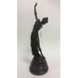 A Bronze figure of a standing Lady with outstreched arm. 56cm in height.