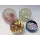 Four glass paperweights