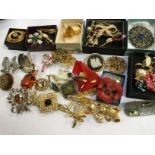 A collection of vintage brooches to include miracle peacock feather,