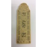 A carved ivory cribbage board