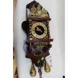 A 20th Century brass faced wall clock, with weights,