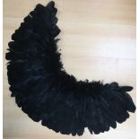 A Mourning cape made from black feathers and down,