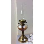 A brass twin burner oil lamp pressed glass reservoir,