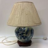 A Chinese blue white lamp base and shade with stand