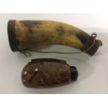 A Powder Horn. 18cm in height. Brass fittings. Missing the filler spout.