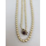 A cultured fresh water pearl opera necklace, with graduated round cream /white pearls,