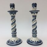 A pair of Portuguese painted, blue and white Wrythern candle sticks,