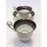 An English porcelain trio, tea and coffee cup and saucer, cobalt blue and gilt borders, pattern No.