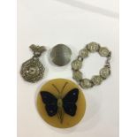 A large butterfly design button and a marcasite cocktail watch on a pin (1930's?);