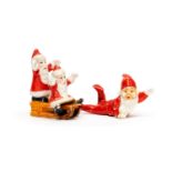 Two Art Deco tinted bisque porcelain santa claus Christmas cake decorations, circa 1930's,