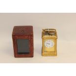 A French gilt metal cased carriage clock, with carry case and key,