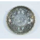 A Chinese white metal circular dish, engraved with foliage in shallow relief,