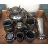 A collection of various pewter items including a lidded jug, various tankards, mugs,