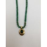 An emerald and 18ct gold pendant necklace,