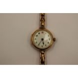 A 1920's 9ct gold mechanical watch, enamel dial, dial diameter approx 23mm,