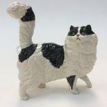 A Beswick black and white figure of a cat, with its head to one side,