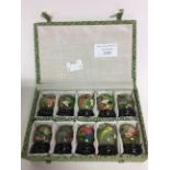 A cased set of ten Chinese Jade hand painted balls on plynths,