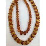 A faceted amber bead necklace wIth graduated round beads, length approx 40'', weight approx 87gms,