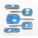 A Walker and Hall Art Deco five piece dressing table set with blue enamel over engine turned