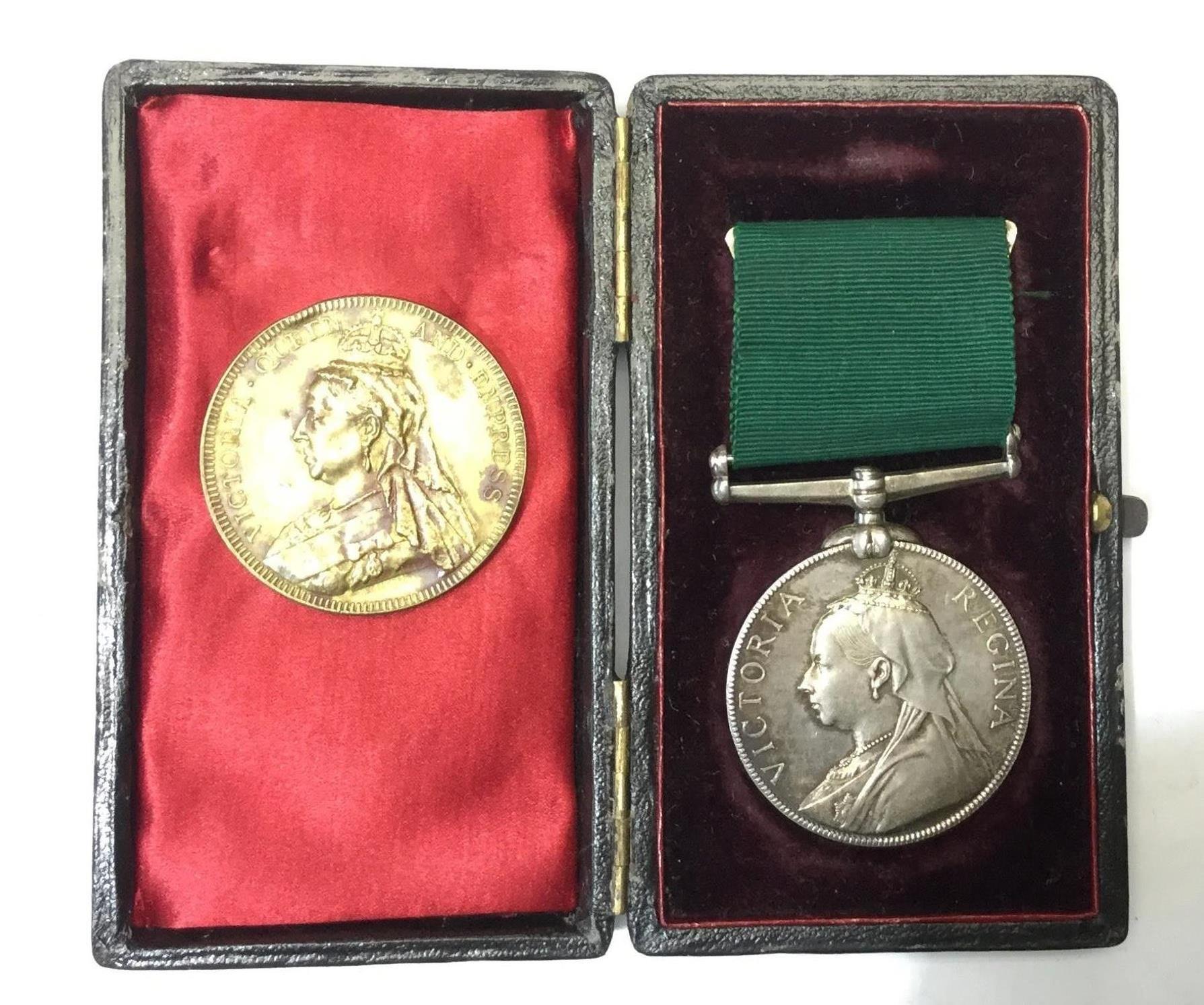 A cased Victorian Volunteer Long Service medal complete with ribbon. Unamed example.