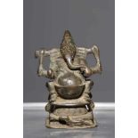 GANESHAbronze,India, 16th century,H: 7,5 cmVotive sculpture of Ganesha seated on elaborate 8-pointed