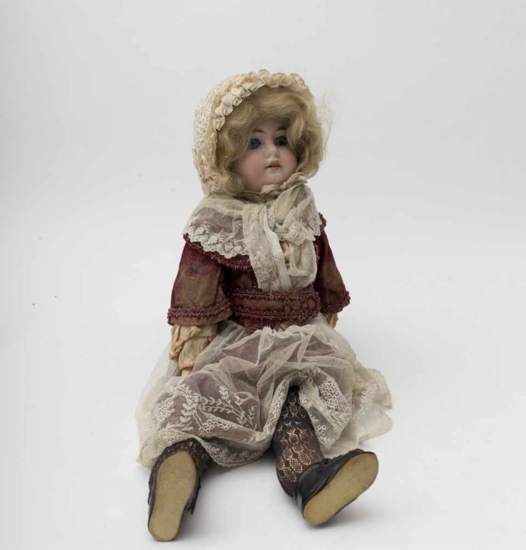 German doll With biscuit head and torso, open mouth, branded “1894 AM DEP”, blue sleeping eyes,