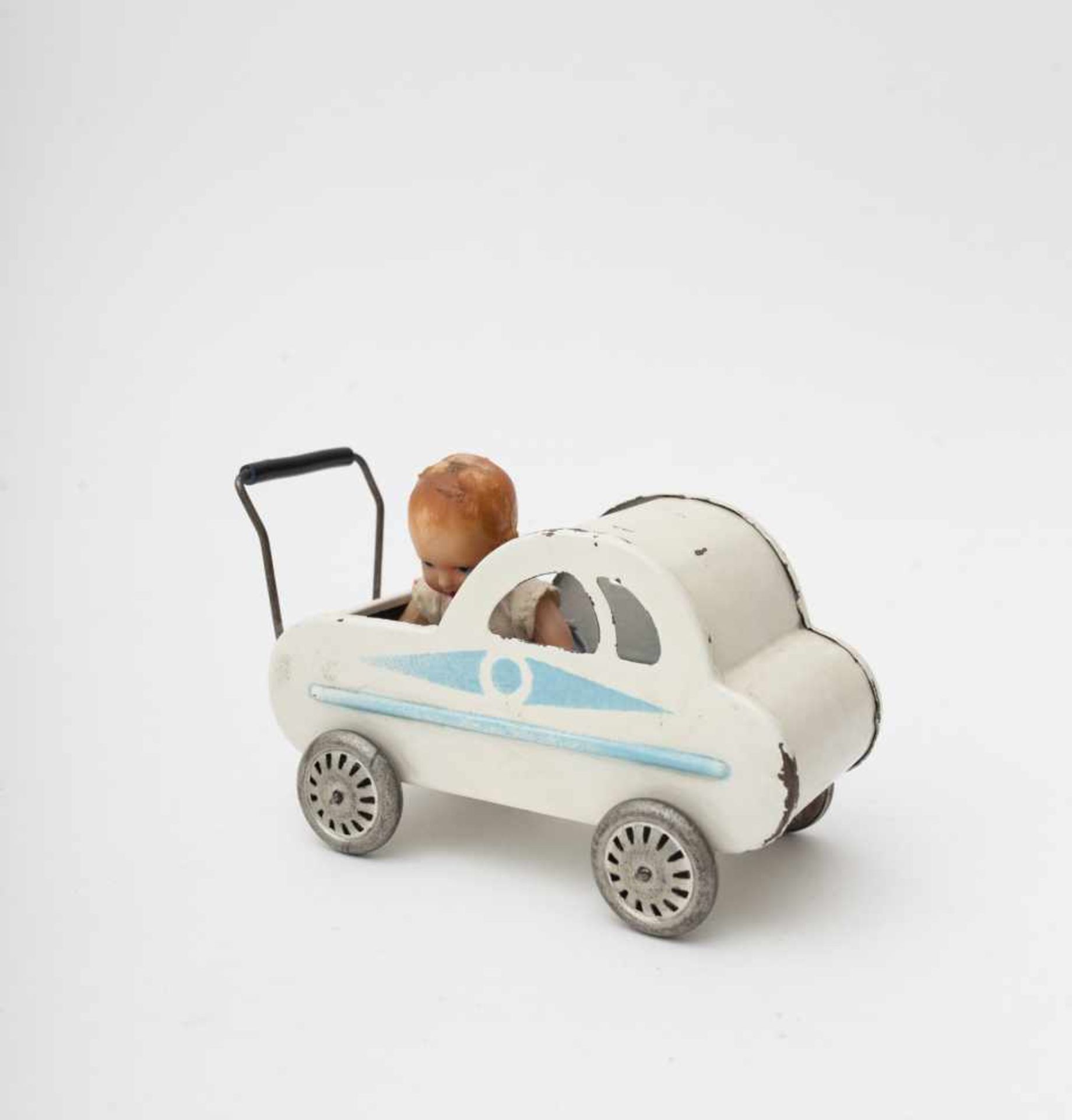 Mignonette pram 1920’s, sheet metal painted with a stencil, with celluloid baby, L=14cm.