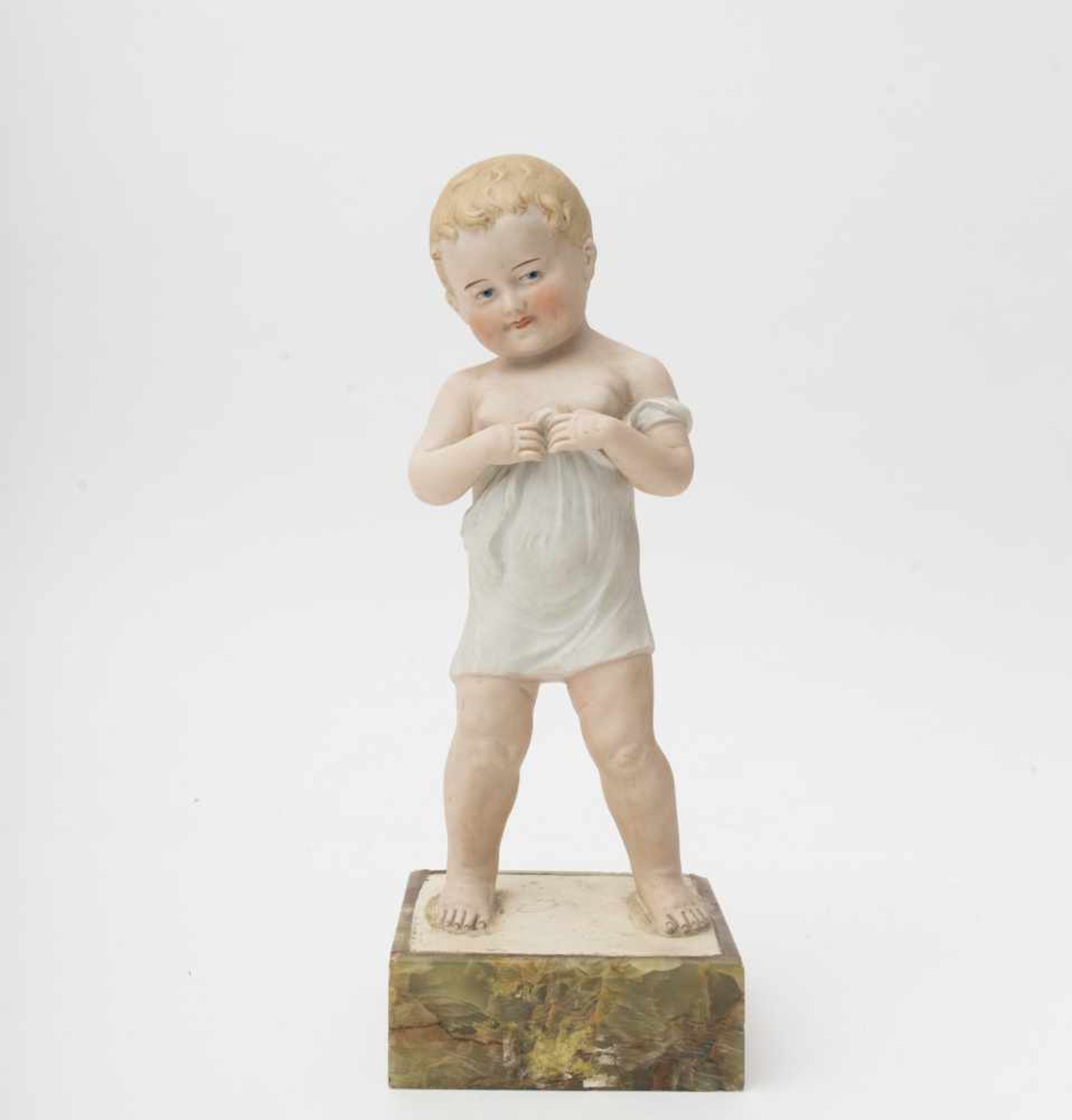 Small boy Made of biscuit, showcase figure, set on an onyx stand, 1930’s German make, H=29cm.