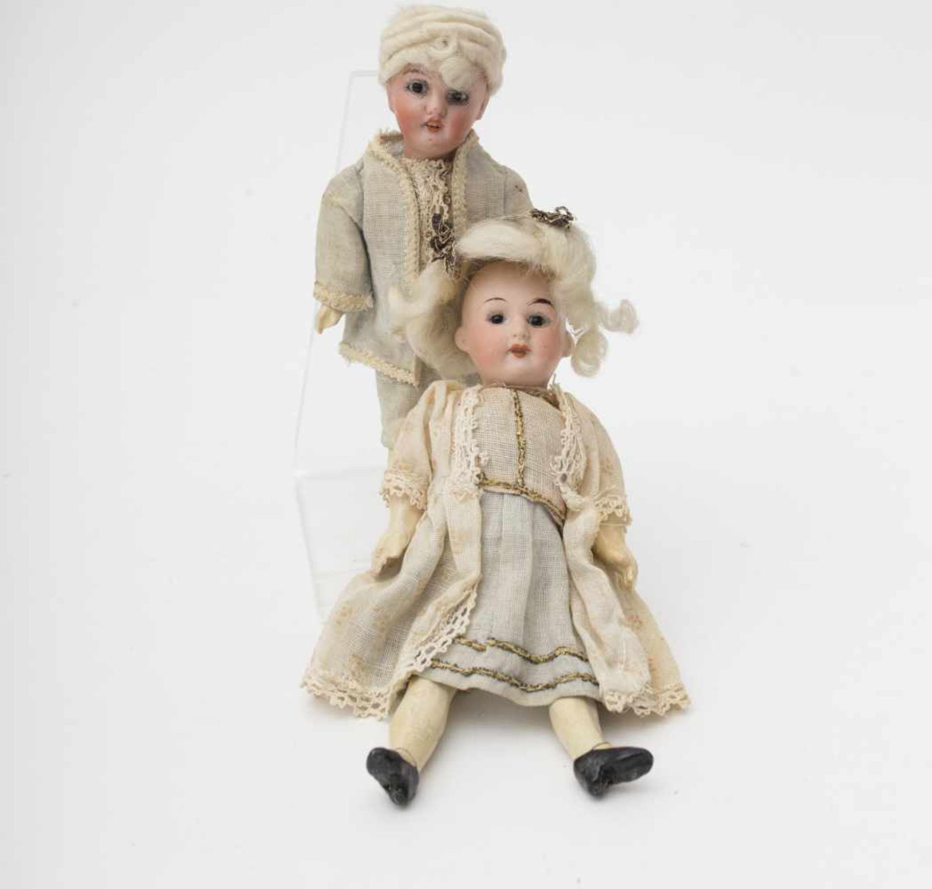 Pair of dolls With biscuit head, open mouth, German origin, fixed glass eyes, dressed in 18th