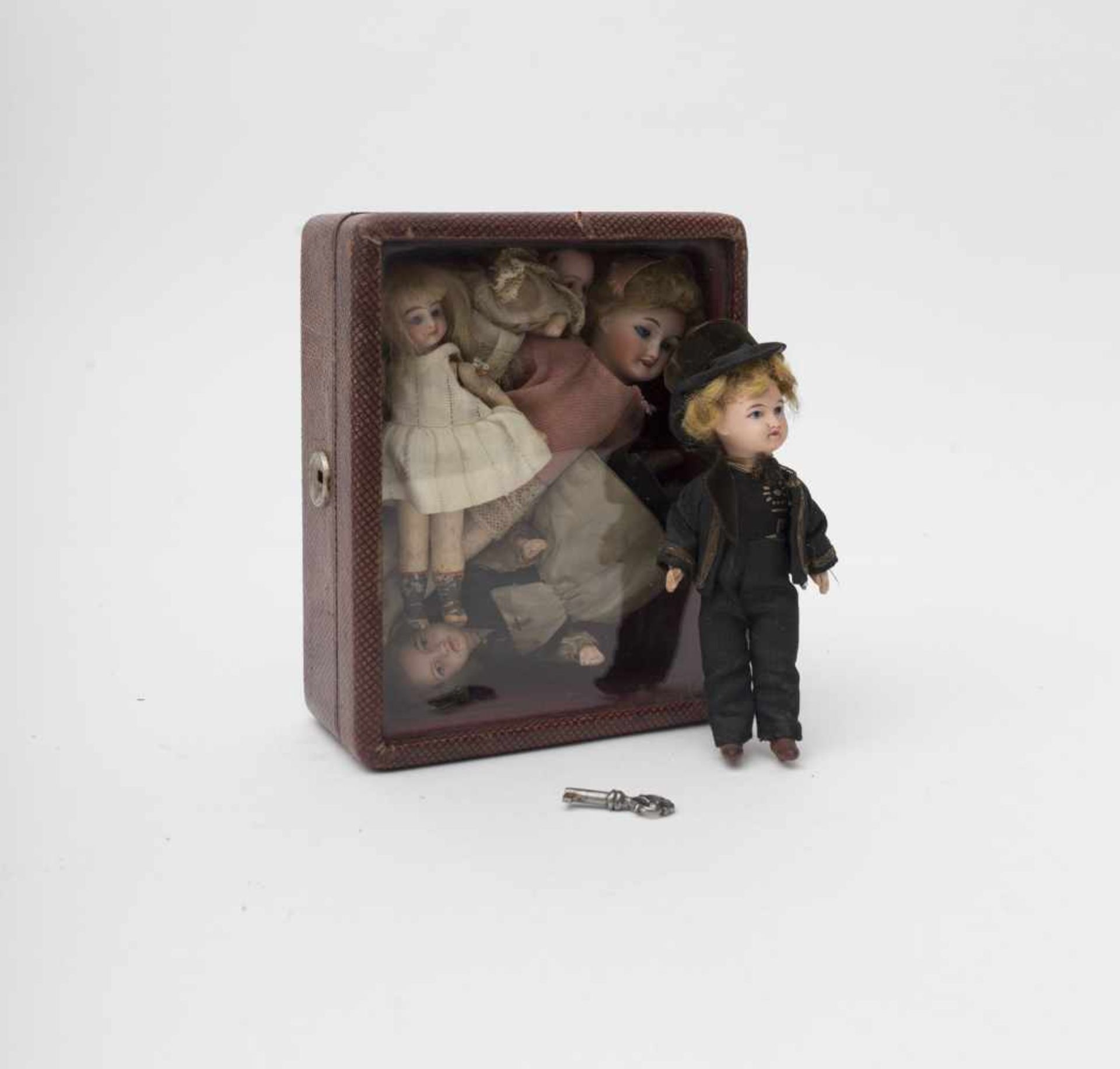 Five mignonettes Including a couple of UNIS France folkloric dolls, in a captioned box with glass