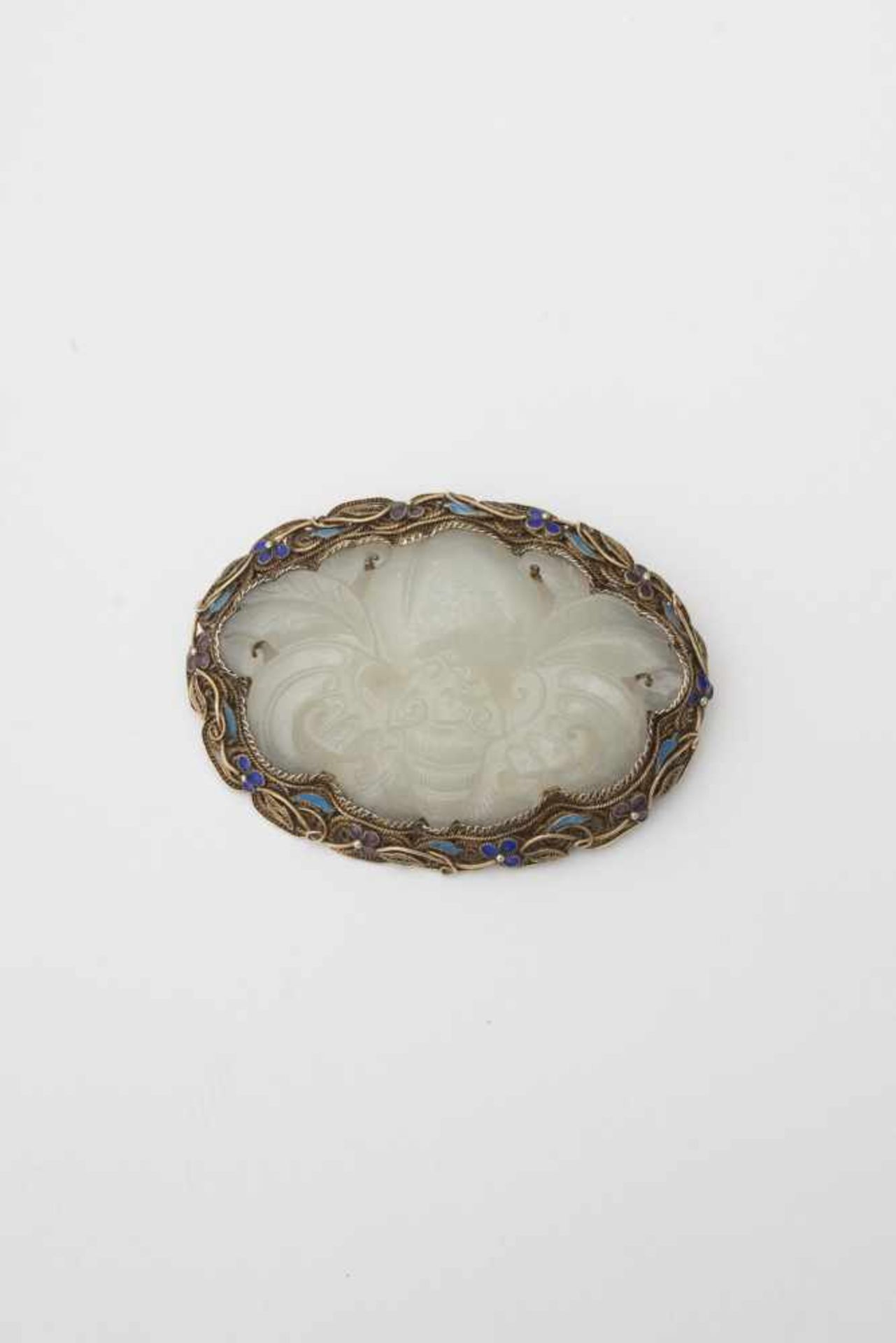 Brooch set with jade - China, early 20th century Gilded silver filigree decorated with blue and