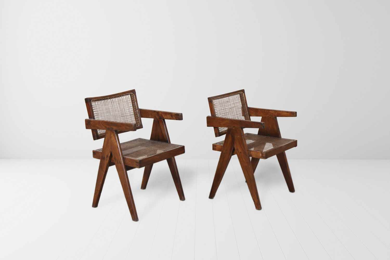 Pierre Jeanneret (1896-1967) Elegant cane office chairs, 1956 Pair of teakwood and cane chairs.