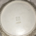 A nicely made, white cinnabar decorative plate with scroll and flower rim and a couple in a boat - Image 2 of 2