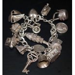 Silver Charm Bracelet Loaded With 15 Charms To Include An Articulated Fish, Hinged Cash Register, Se