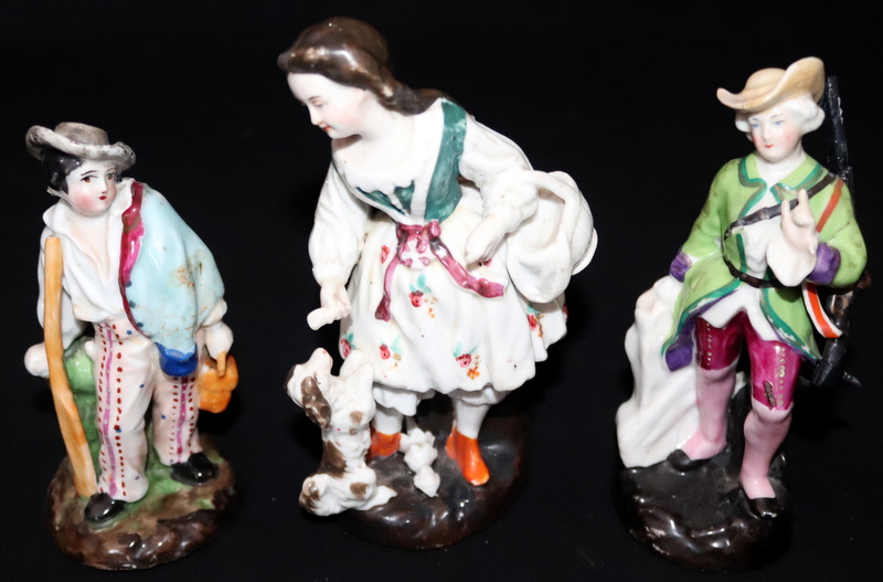 Set Of Three Porcelain Figures; One Depicting A Woman With Oar