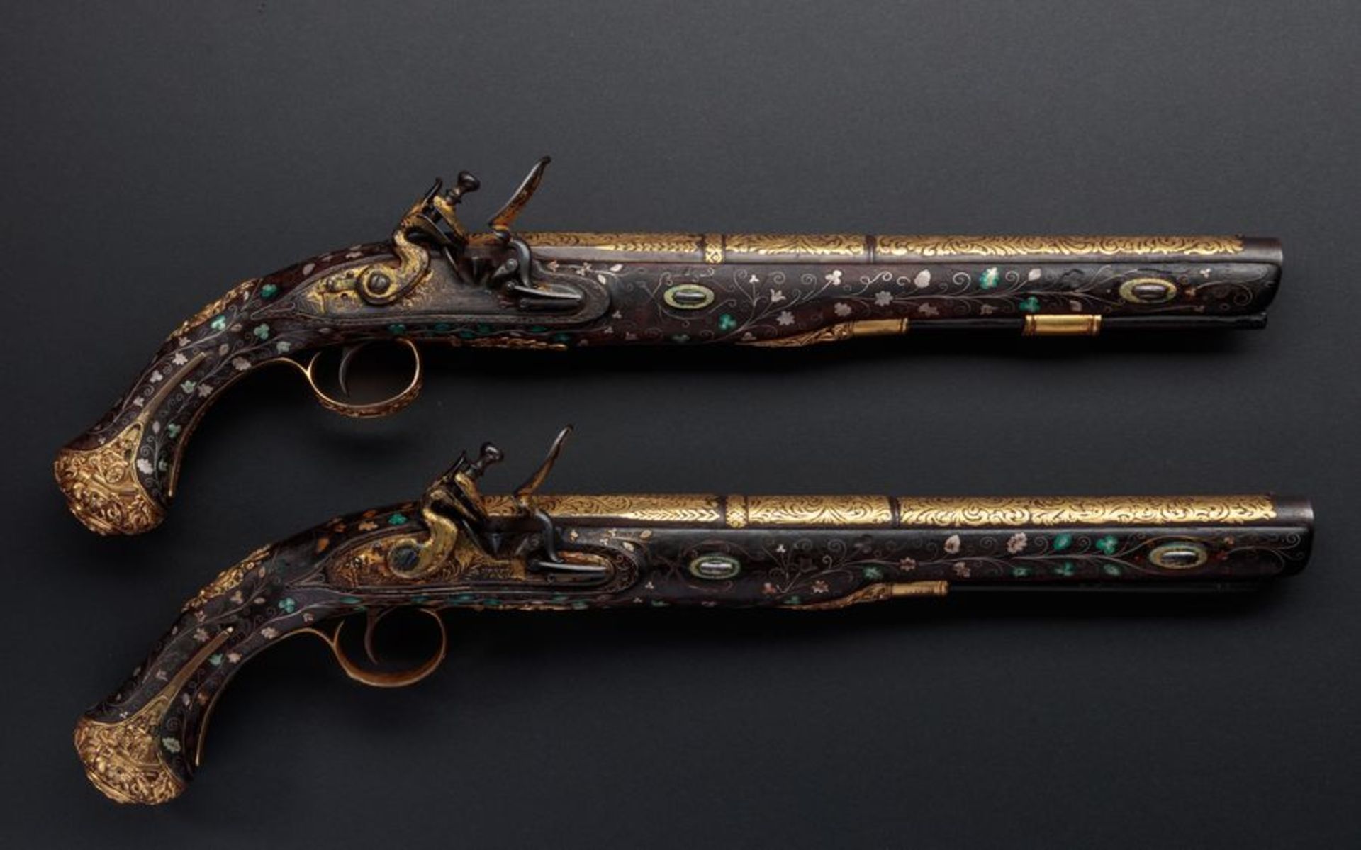 A pair of sumptuously decorated Turkish pistols with int locks, produced in England [...]