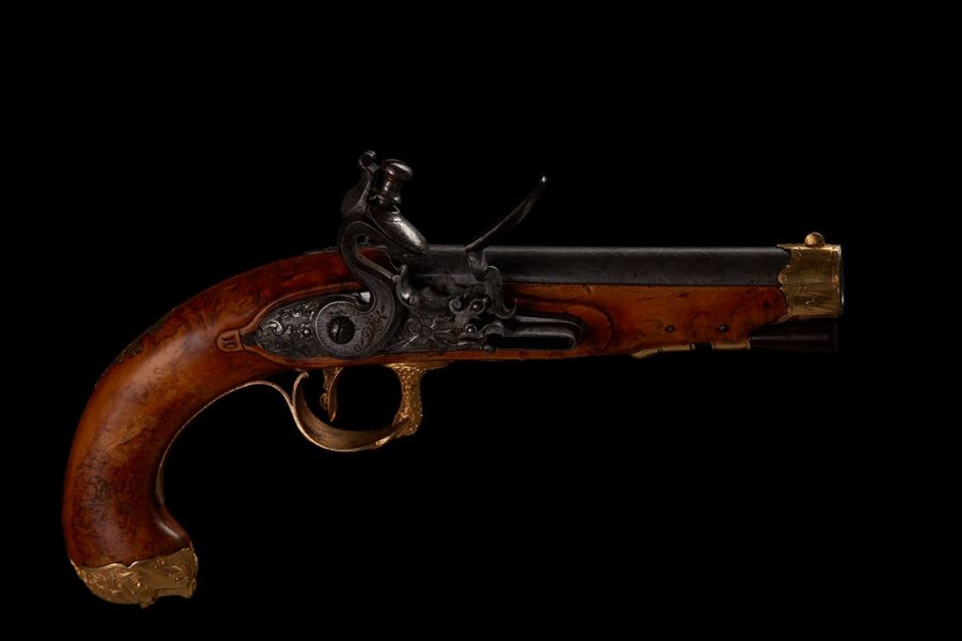 Russian intlock pistol With gilded chased mounts stocked in masur birch, the curved [...]