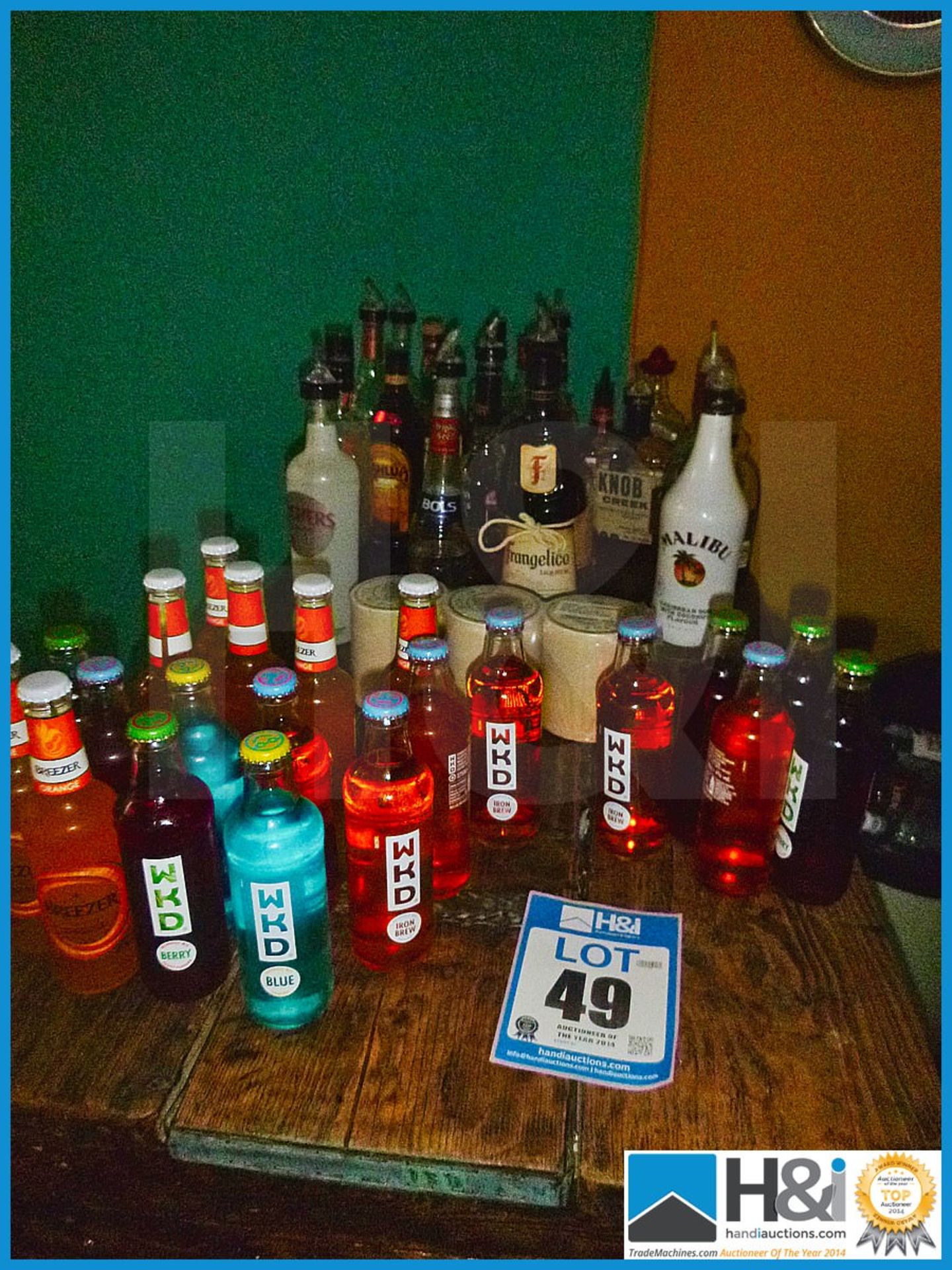 Good mixed lot of part bottles of spirits, WKD and stack of new drinks coasters