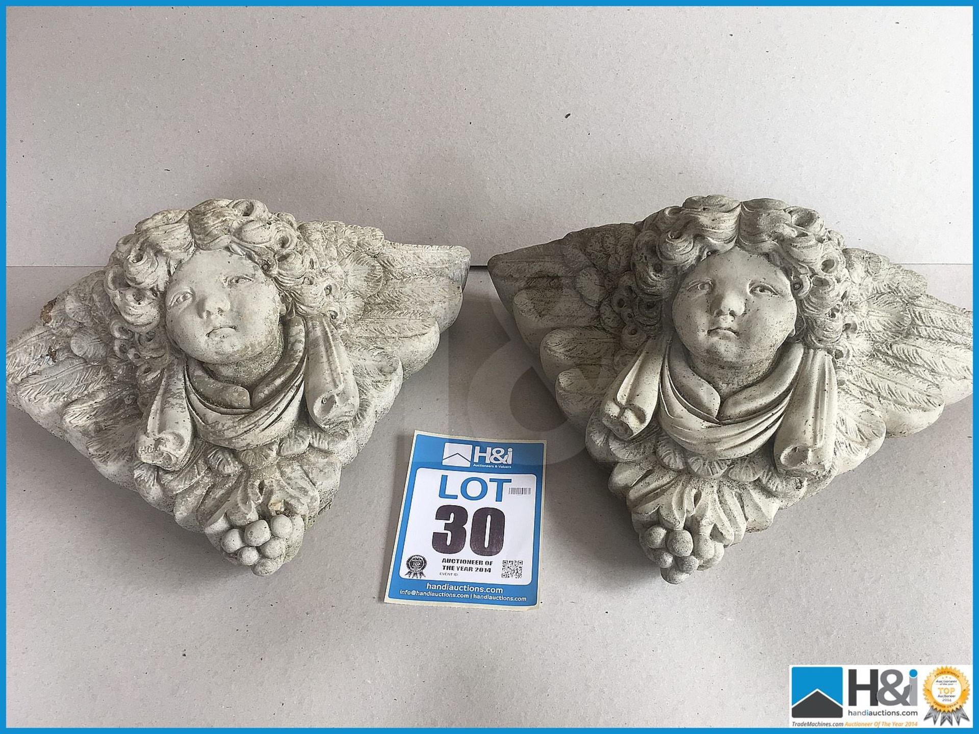 A pair of delightful vintage stone cherub planters in excellent condition.