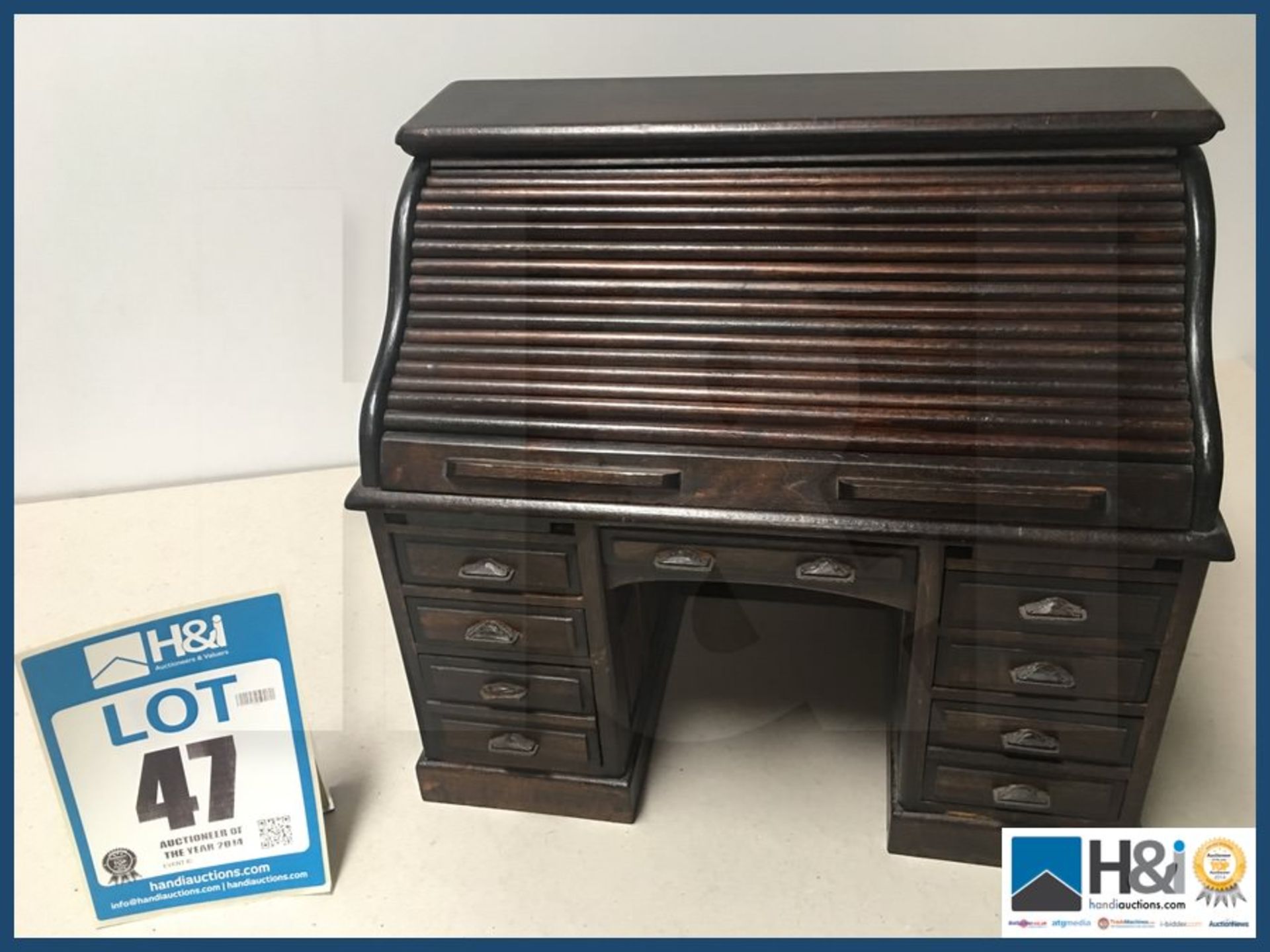 Minature roll top oak desk with all working drawers 14" wide x 8" deep x 13" high.