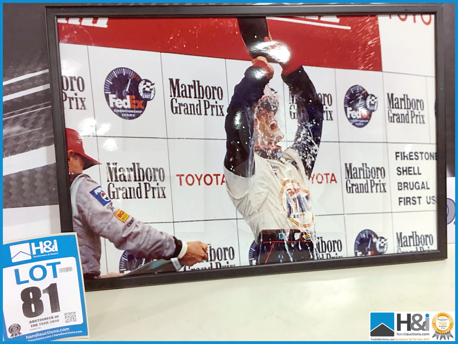 Framed photo of IndyCar podium win - 27in 18in. From the Cosworth Archives -- MC:N/A CILN:N/A