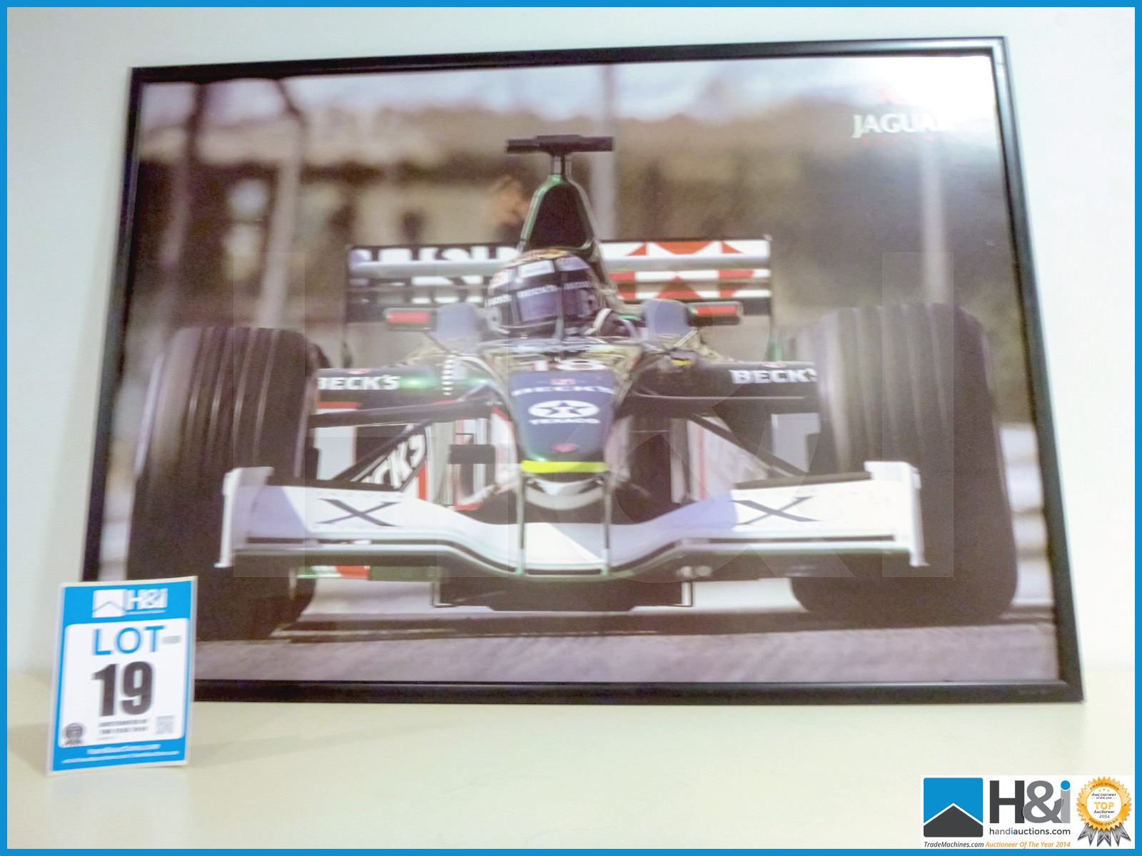 Framed picture of Jaguar Cosworth Powered F1 car. Eddie Irvine. Approx 41in X 29in -- MC:N/A CILN:N/ - Image 2 of 2